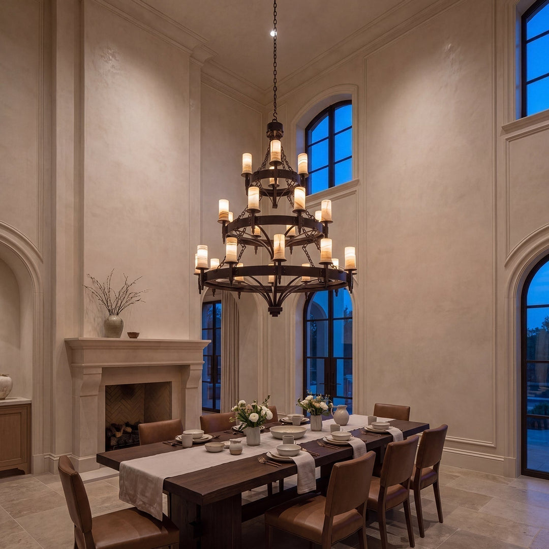 Handcrafted wrought iron chandelier illuminating a high-ceiling dining room with warm 2700K light.