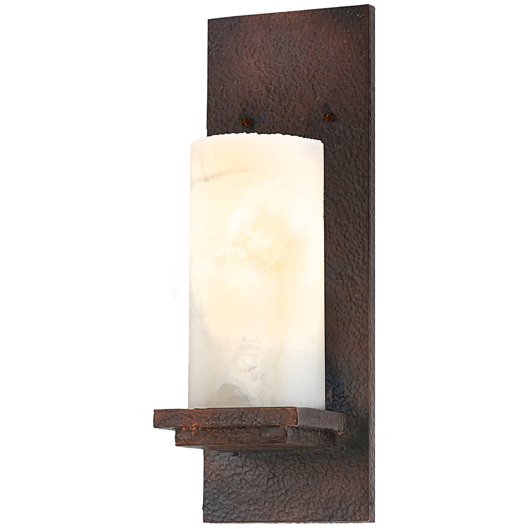 forged iron wall sconce with cylindrical alabaster shade and hammered backplate, handcrafted lighting by manufacturer in Dallas Texas
