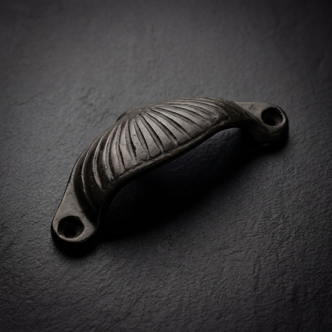 Arcus handcast bronze fluted cabinet pull in solid bronze hardware with curved profile and detailed ridged surface
