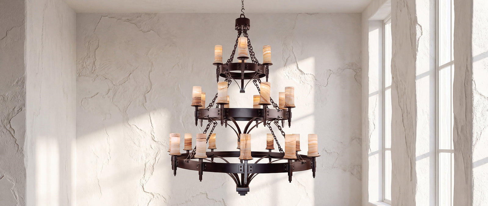 Craftsman three-tier wrought iron chandelier with natural alabaster shades installed in a bright architectural interior.