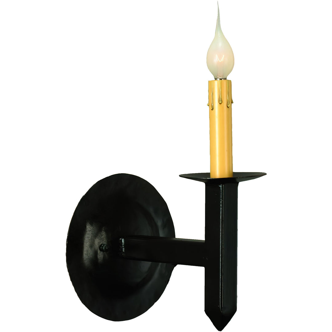 Mission one-light wrought iron wall sconce with circular backplate, geometric iron arm, pointed detail, and elevated candle-style light.