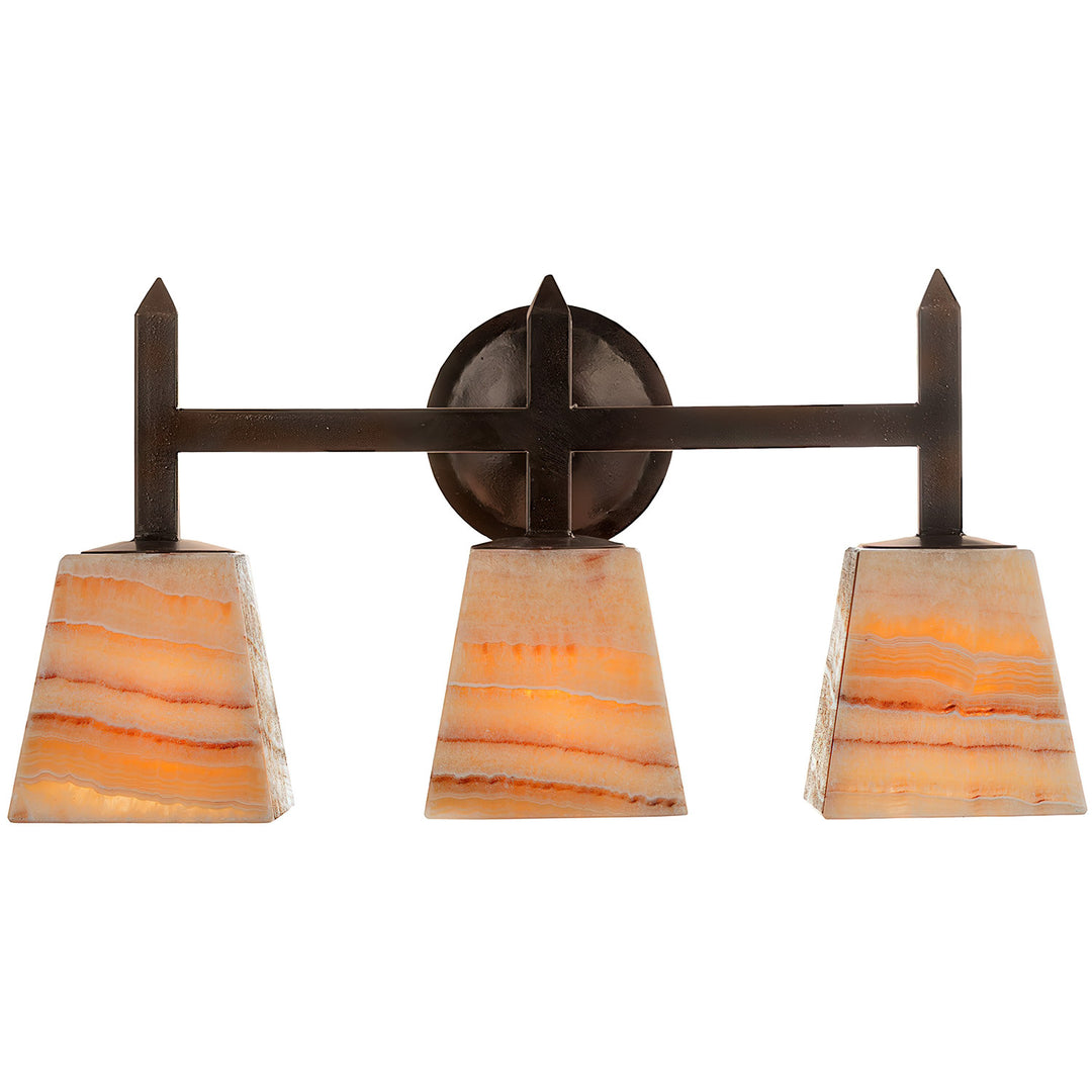 Mission three-light alabaster vanity light with tapered natural stone shades, geometric iron framework, pointed details, and circular backplate.