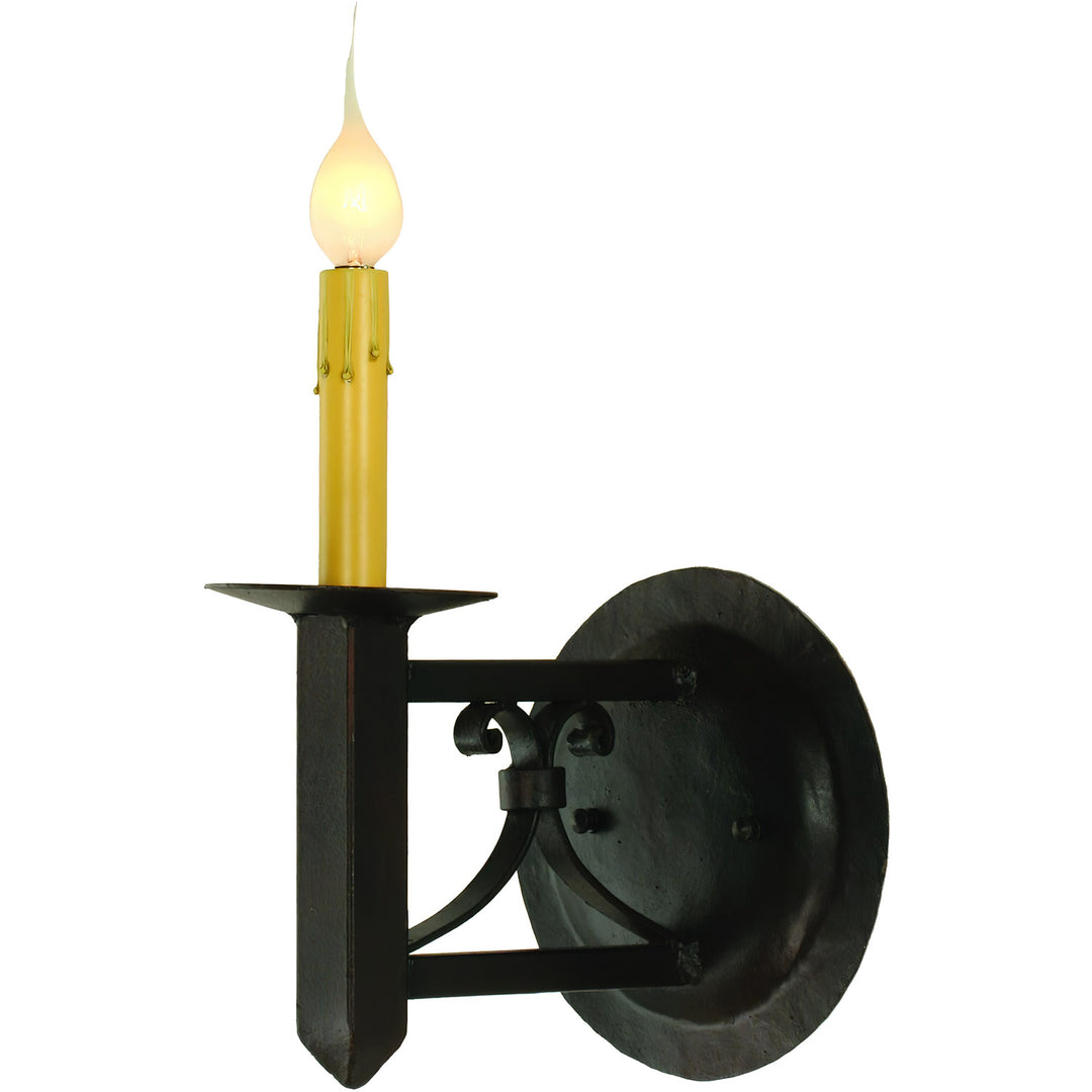 Mission Forge one-light wrought iron wall sconce with Spanish Colonial scrollwork, pointed terminal, round backplate, and candle-style light.