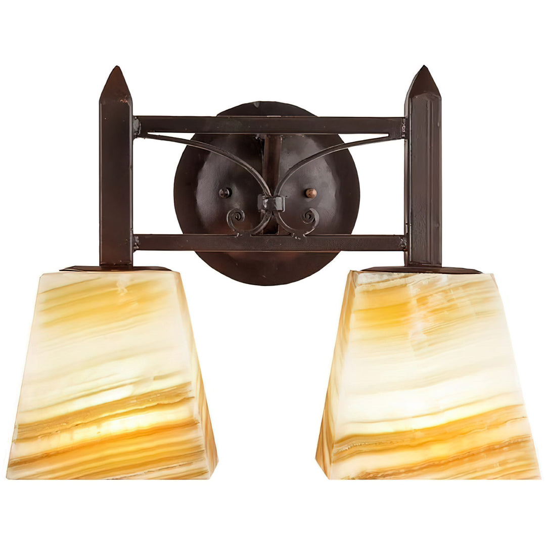 Mission Forge two-light alabaster vanity with tapered natural stone shades, Spanish Colonial scrollwork, pointed terminals, and circular backplate.