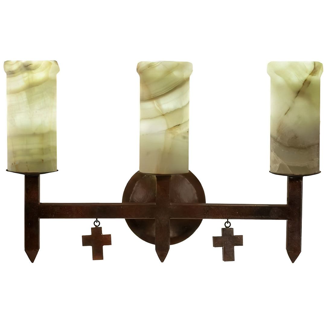 Mission three-light alabaster wall sconce with natural stone shades, pointed architectural ironwork, circular backplate, and suspended mini crosses.