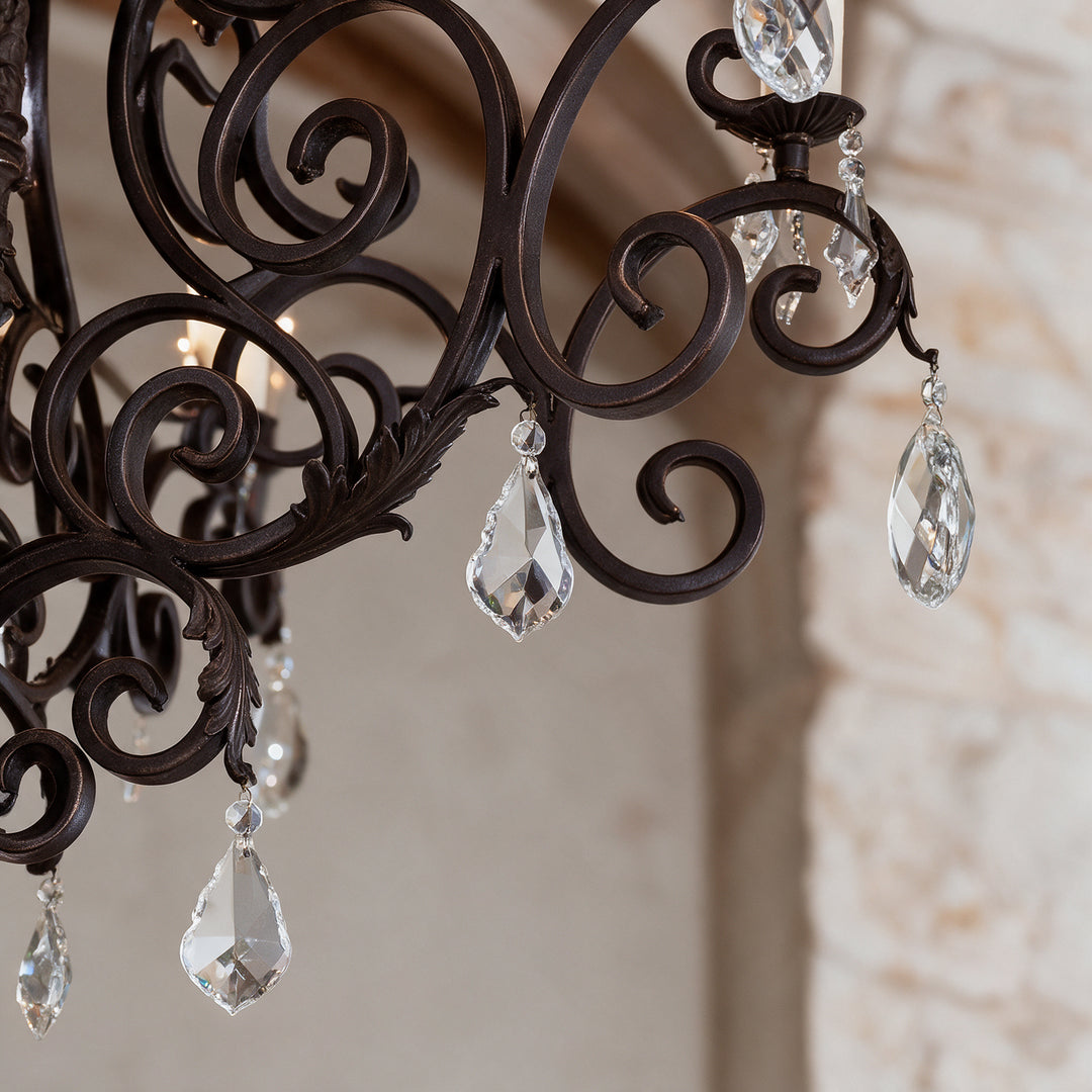 Close-up of Monte Carlo Heritage chandelier showing dark wrought iron scrollwork, leaf detailing and suspended faceted crystal drops.