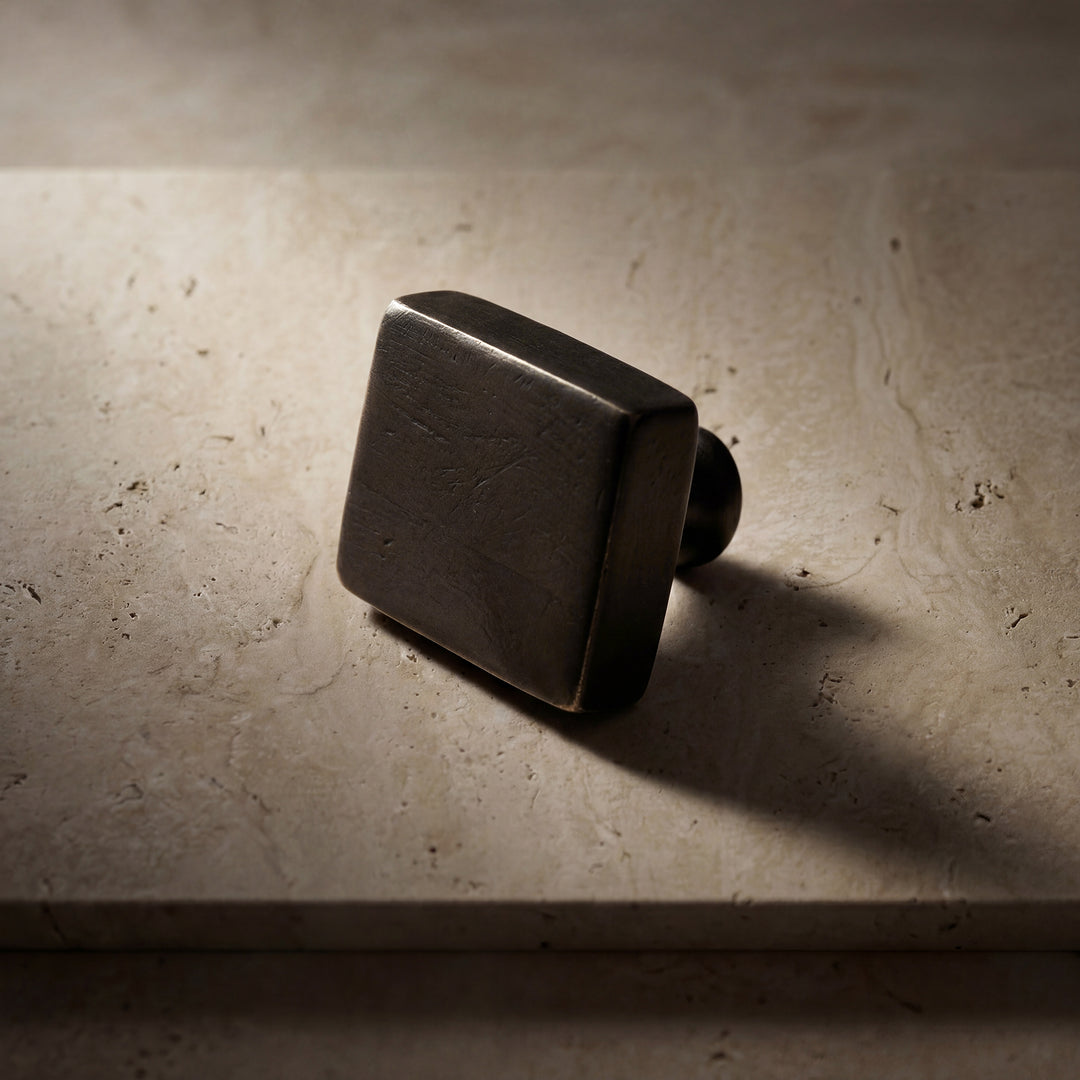 Detail of Ridge handcast bronze cabinet pull showing linear ridged texture, solid bronze hardware, and handcrafted surface variation
