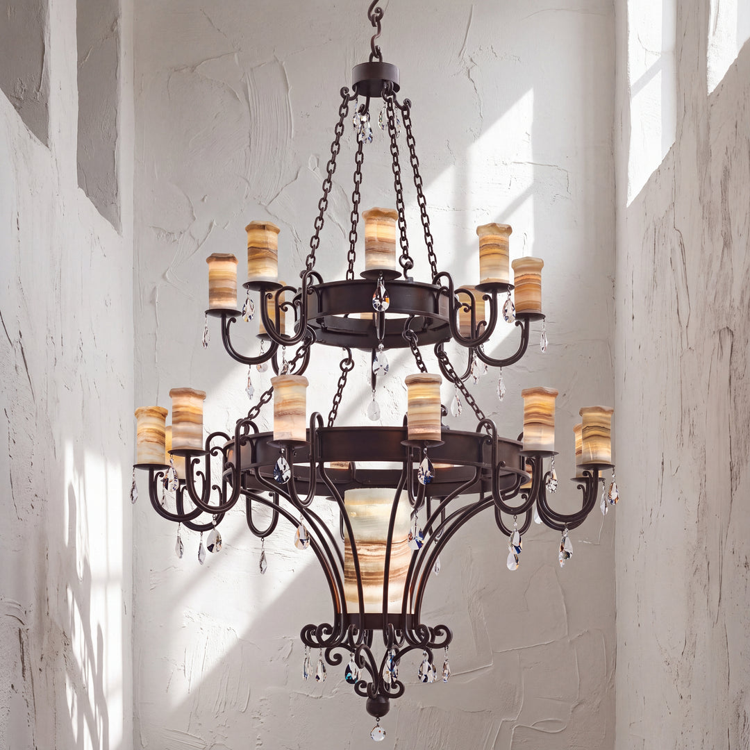 Trevi heirloom two-tier alabaster chandelier with sculptural ironwork, luminous natural stone shades, and suspended faceted crystal accents.