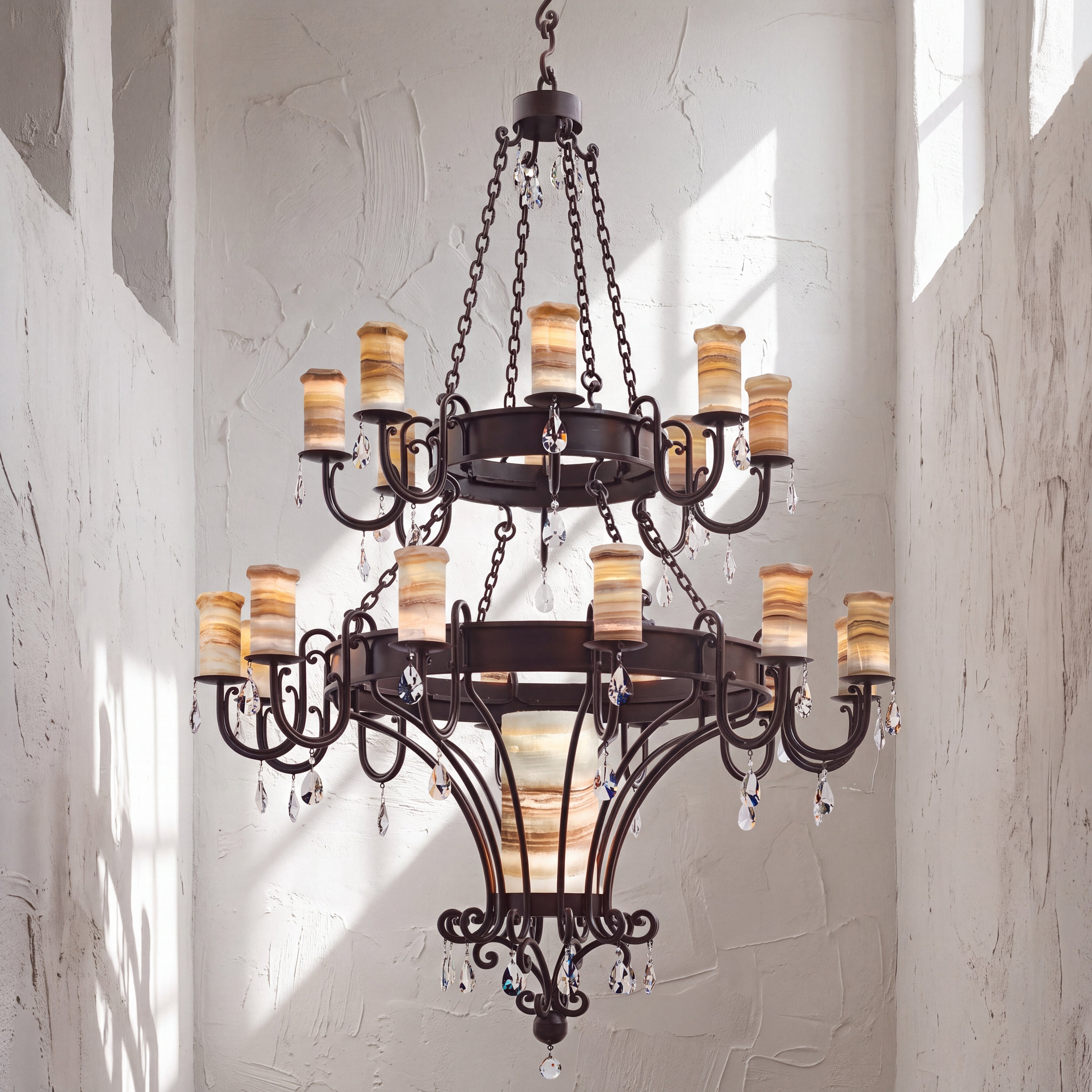Trevi heirloom two-tier alabaster chandelier with sculptural ironwork, luminous natural stone shades, and suspended faceted crystal accents.